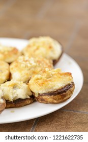 Mushrooms Stuffed With Crab And Cheese On White Plate