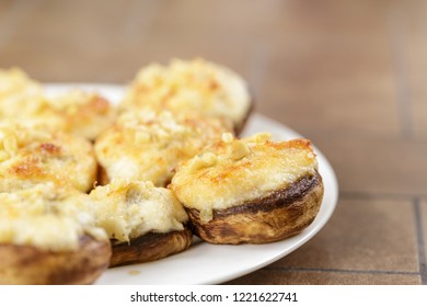 Mushrooms Stuffed With Crab And Cheese On White Plate