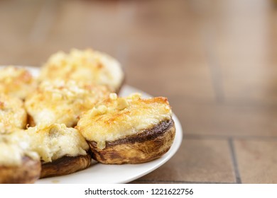 Mushrooms Stuffed With Crab And Cheese On White Plate