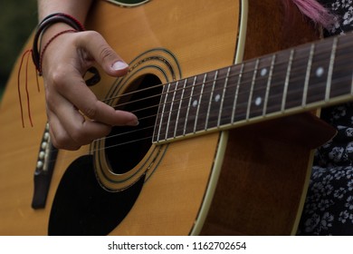 music acoustic guitar instrument concept of right female hand on string - Powered by Shutterstock