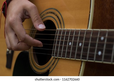 music acoustic guitar instrument concept of right female hand on string - Powered by Shutterstock