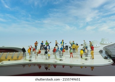 A Music Band Gives An Open Air Concert On An Electric Guitar To An Enthusiastic Audience. Wide View, Blue Cloudy Background,
Concept: Live Music Art