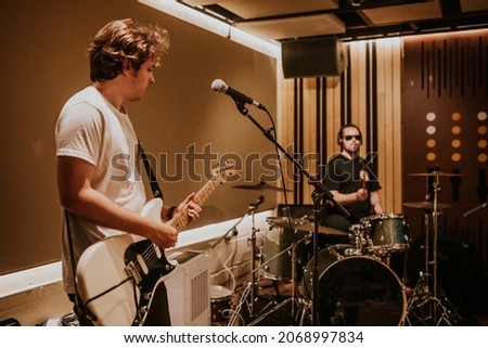 Music band guitarist performing repetition in recording studio