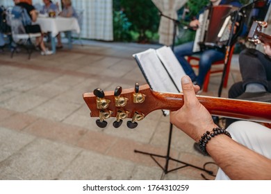 Music Band Holding Guitar On Small Wedding Reception