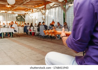 Music Band Holding Guitar On Small Wedding Reception