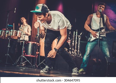 Music Band Performing On A Stage 