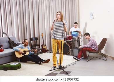 Music band performing in a recording studio - Powered by Shutterstock