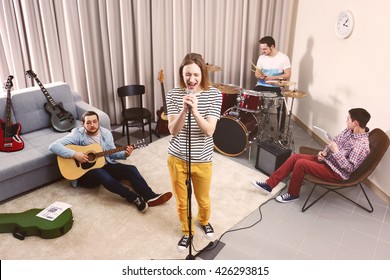 Music band performing in a recording studio - Powered by Shutterstock