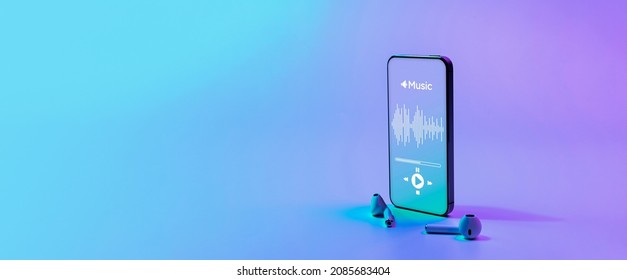 Music banner. Mobile smartphone screen with music application, sound headphones. Audio voice with radio beats on neon gradient background. Broadcast media music banner with copy space - Shutterstock ID 2085683404
