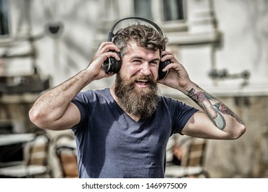 Music beat for energetic mood. Rhythm for walk. Man bearded hipster headphones listening music. Hipster enjoy excellent sound song in earphones. Walking with music. Excellent music playlist.