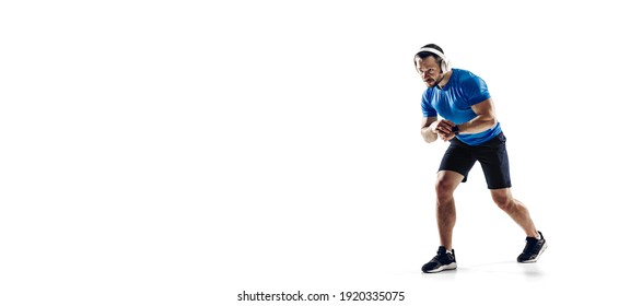 Music. Caucasian Professional Male Athlete, Runner Training Isolated On White Studio Background. Muscular, Sportive Man. Concept Of Action, Motion, Youth, Healthy Lifestyle. Copyspace For Ad. Flyer