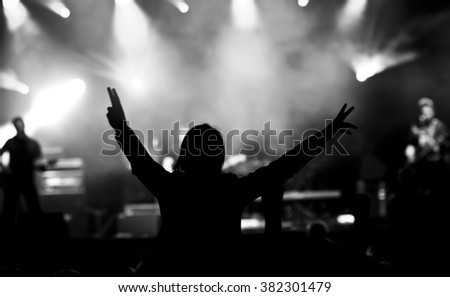 Music concert, silhouette of girls hands raised up, enjoying music in the club, luxury night performance, active lifestyle, having fun. Concert background.