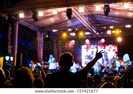 Music concert, silhouette of girls hands raised up, enjoying music in the club, luxury night performance, active lifestyle, having fun. Concert background. 