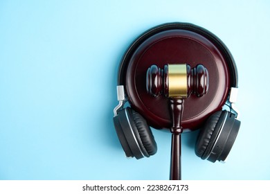 Music copyright law concept. Headphones and judge gavel background with copy-space. Music piracy and owners rights - Shutterstock ID 2238267173