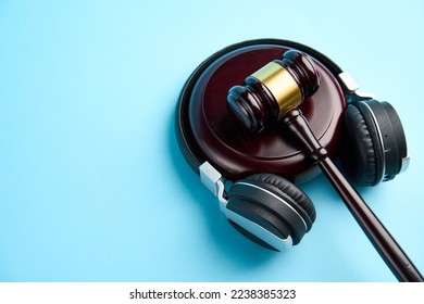 Music copyright law concept. Headphones and judge gavel background with copy-space. Music piracy and owners rights - Shutterstock ID 2238385323