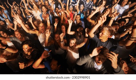 Music, dance and party with crowd at concert for rock, live band performance or festival. New year, energy and disco with audience of fans listening at celebration for techno, rave or nightclub event - Powered by Shutterstock