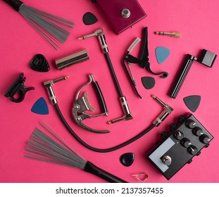 Music equipment on a hot pink background. Guitar accessories. 