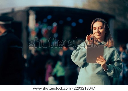 
Music Festival Organizer Wearing a Headset Holding a Pc Tablet. Confident public relations specialist hosting a concert event
