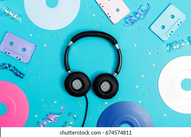 Music Flat Lay Objects With Vinyl Records And Cassette Tapes On A Blue Background