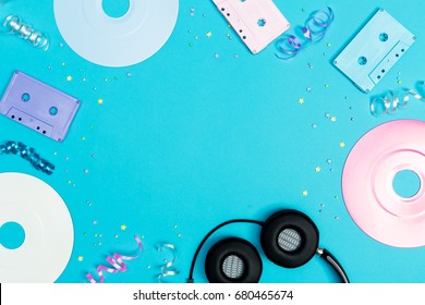 Music Flat Lay Objects With Vinyl Records And Cassette Tapes On A Blue Background