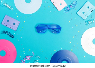 Music Flat Lay Objects With Vinyl Records And Cassette Tapes On A Blue Background