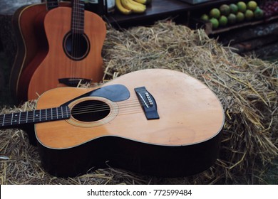 Music instrument, Three acoustic guitars with hay. 