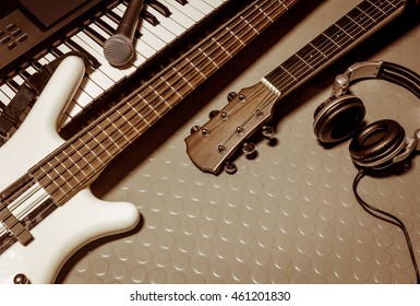 Music Instruments Band The  Classic Guitar,microphone,headphones,electronic Piano Bass On Floor Background With Copy Space.