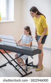 Music Lesson. Girl Having A Private Music Lesson And Looking Involved