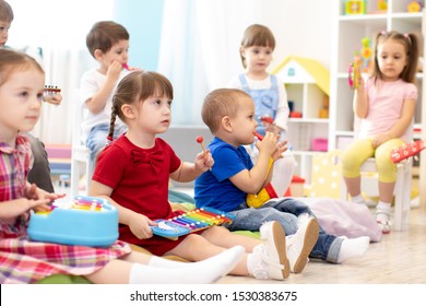 Music Lesson For Group Of Children In Kindergarten Or Kids Centre