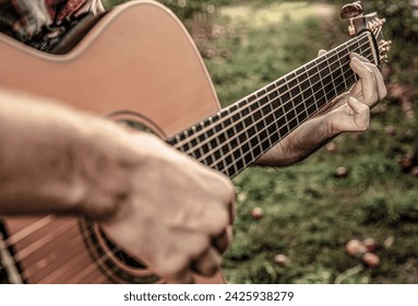 Music lifestyle man playing guitar nature concept. Hands of man musician playing guitar. Music concept. Man's hands playing acoustic guitar, close up. Acoustic guitars playing. Guitars acoustic. - Powered by Shutterstock