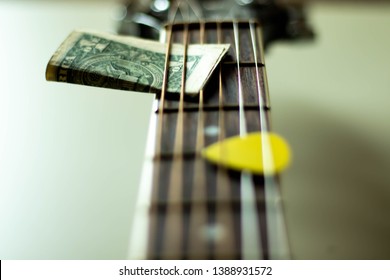 Music and money concept- making money while playing guitar