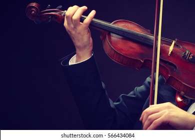 Music Passion, Hobby Concept. Close Up Young Man Man Dressed Elegantly Playing On Wooden Violin. Studio Shot On Dark Background