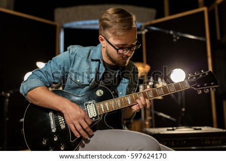 Similar – Foto Bild Mann spielt auf E-Gitarre vor dunklem Hintergrund, Nahaufnahme