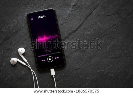Music player on mobile phone with earphones