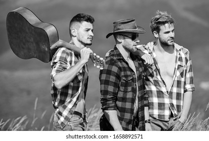 music is poetry. men with guitar in checkered shirt. western camping. campfire songs. happy men friends with guitar. friendship. hiking adventure. cowboy men. group of people spend free time together.