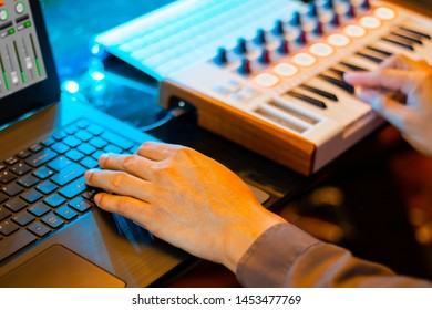 Music Producer Hands Composing A Song On Laptop Computer And Midi Keyboard In Home Recording Studio. Music Production Concept