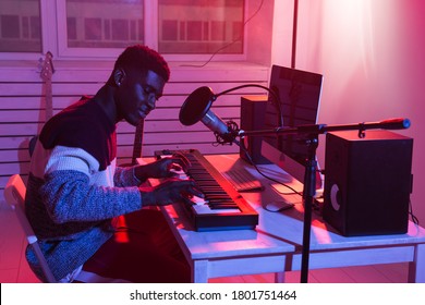 Music Production Concept - Male Sound Producer Working In Home Recording Studio.