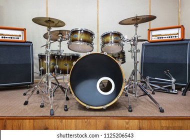 Music Rehearsal Space With Drum Kit And Musical Equipment.