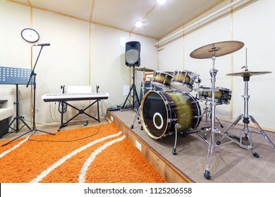 Music Rehearsal Space With Drum Kit And Musical Equipment.