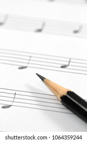 Music Sheet With Handwritten Musical Notes And Black Pencil.