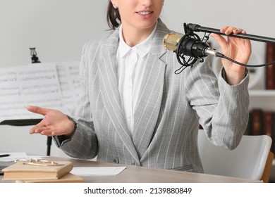 Music Teacher Recording Her Voice In Room, Closeup