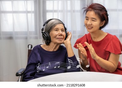 Music Therapy In Dementia Treatment On Elderly Woman.