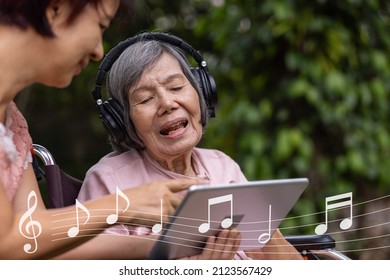 Music Therapy In Dementia Treatment On Elderly Woman.