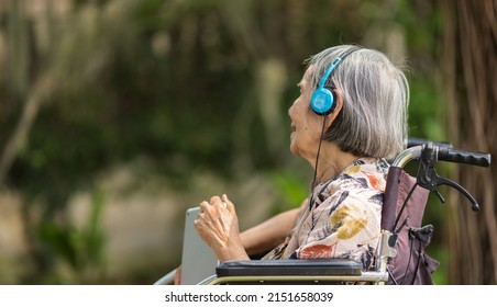 Music Therapy In Dementia Treatment On Elderly Woman.