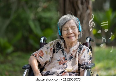 Music Therapy In Dementia Treatment On Elderly Woman.