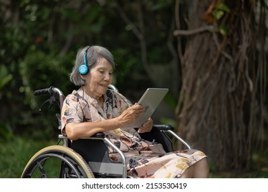 Music Therapy In Dementia Treatment On Elderly Woman.