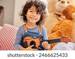 Music, thinking and toy guitar with boy in bedroom of home for instrument fun or practice. Idea, learning and smile with happy child playing pretend musician on sofa in apartment to relax for weekend