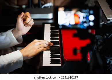 Music Vlogger Streaming A Live Video While Playing Piano In Home Studio