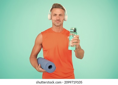 Music for workout. Yoga is my hobby. Personal training. Challenge multiple muscle groups. Man practicing yoga at home. Mature sportsman with yoga mat. Workouts with modifications for different levels