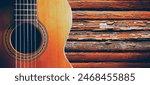 Musical design with acoustic guitar. Spanish guitar and wood wall.Music background